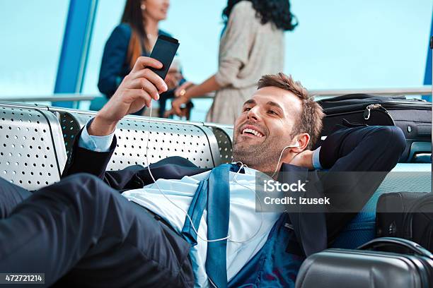 Businessman Waiting For The Flight Using Smart Phone Stock Photo - Download Image Now