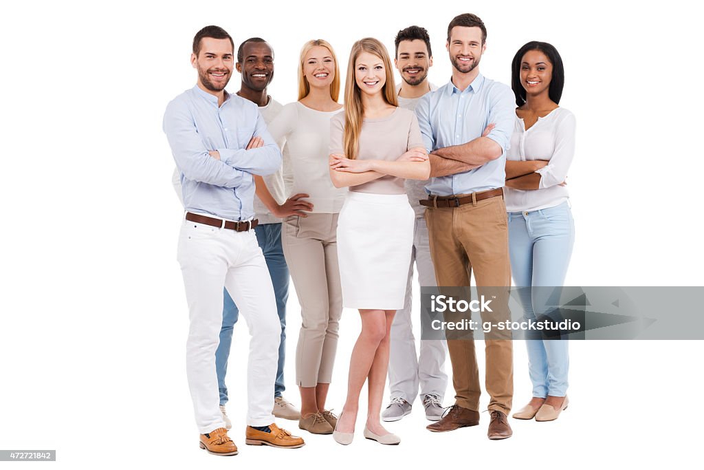 Proud to be a team. Full length of multi-ethnic group of people in smart casual wear looking at camera and smiling while standing against white background Group Of People Stock Photo