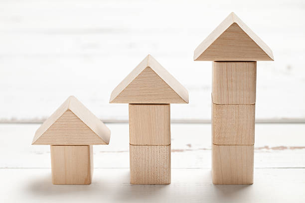 istock Wooden toy house on white table 472723148