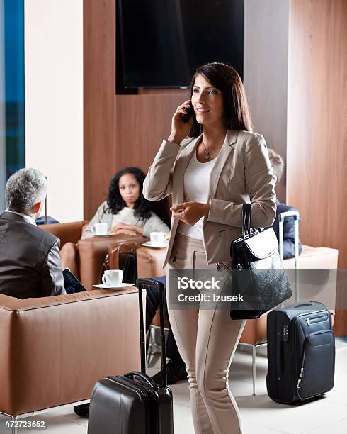 Businesswoman Talking On Mobile Phone In Vip Lounge At Airport Stock Photo - Download Image Now