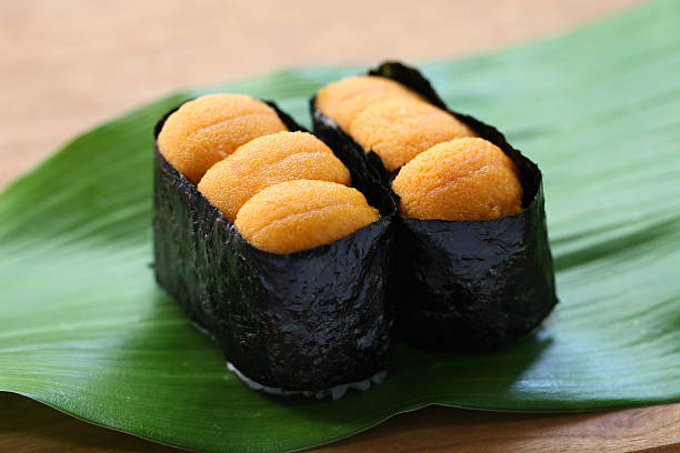 sea urchin roe, japanese sushi, uni gunkanmaki gunkanmaki is a nori wrapped special type of nigirizushi(hand pressed sushi). sea urchin stock pictures, royalty-free photos & images