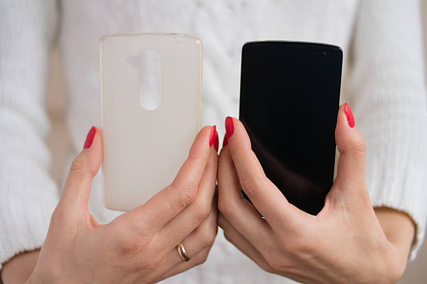 istock The phone and case for the phone in female hands 472730436