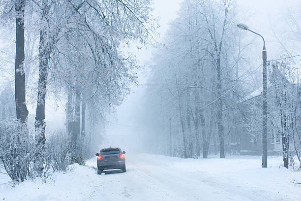istock car on the snowy street 472735356