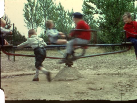 Merry-go-round on playground (vintage 8 mm film)