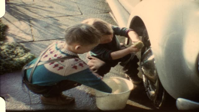 Little boys washing daddy's car (vintage 8mm film)