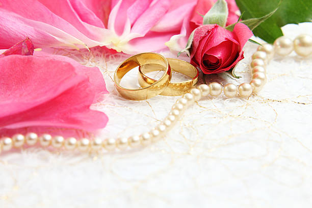istock pair of wedding rings with roses for background image 472778606