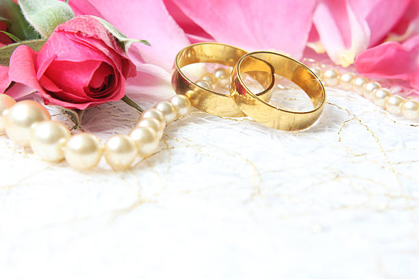 istock pair of wedding rings with roses for background image 472778614