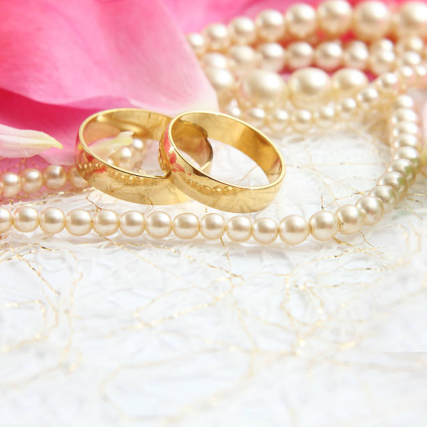 istock pair of wedding rings with roses for background image 472778624