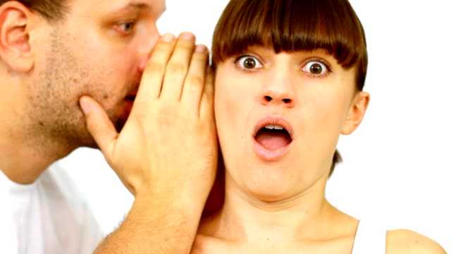 Man telling secret to surpirsed girl