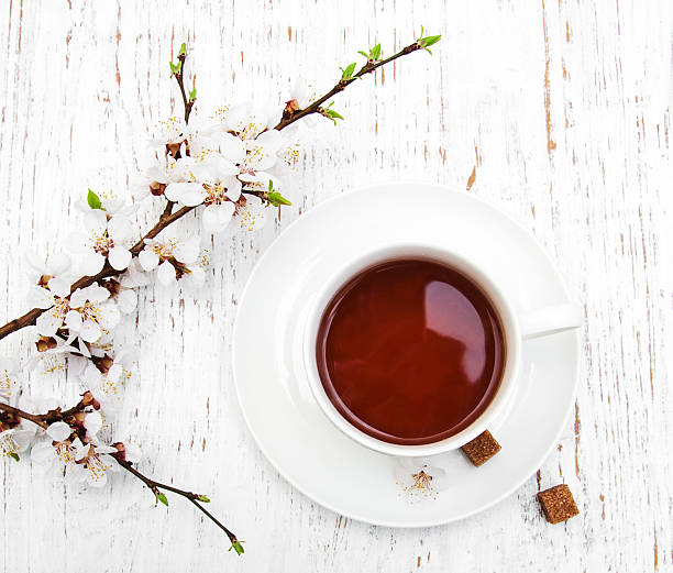 istock Cup of tea and spring blossom 472783152