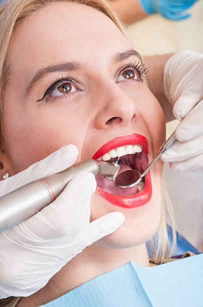 istock Beautiful woman having dental exam 472786248