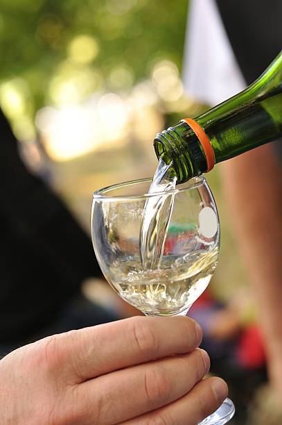 istock White wine pouring into glass 472794817