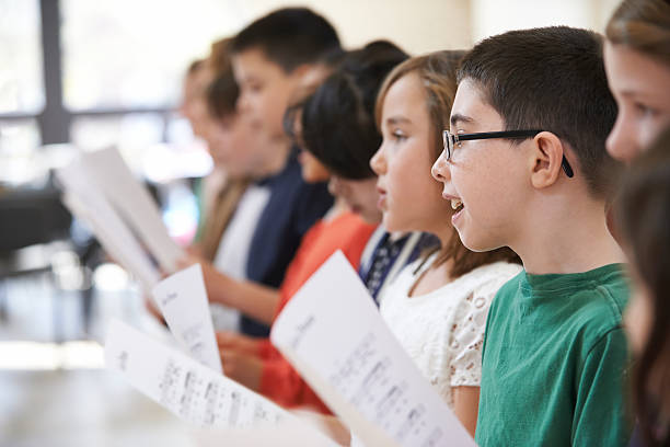 istock Group Of School Children Singing In Choir Together 472795680