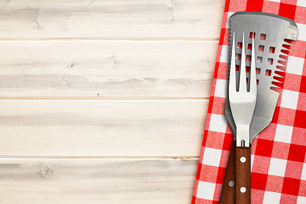 istock Bib utensils on wooden picnic table  472796190