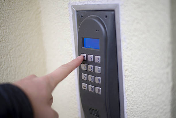 istock Human finger pushing button of house intercom 472796250