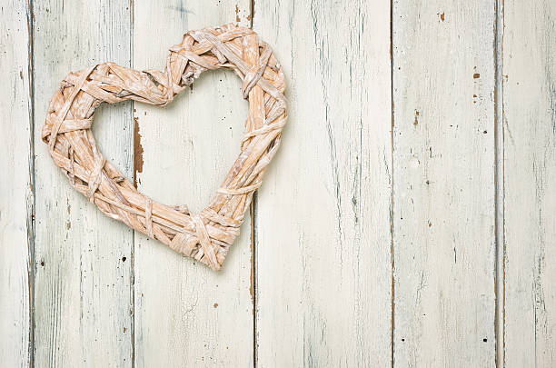 istock Braided heart on a white wooden background 472796714