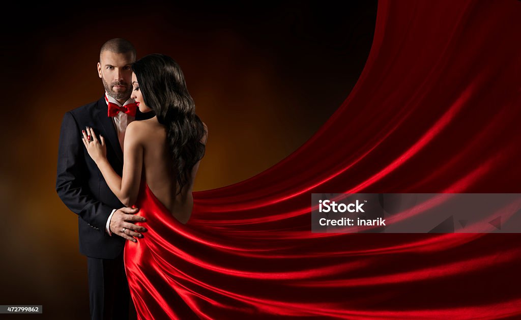 Couple Beauty Portrait, Man in Suit, Woman Red Rich Dress Couple Beauty Portrait, Man in Suit Woman in Red Dress, Rich Lady in Gown, Waving Silk Fabric Couple - Relationship Stock Photo