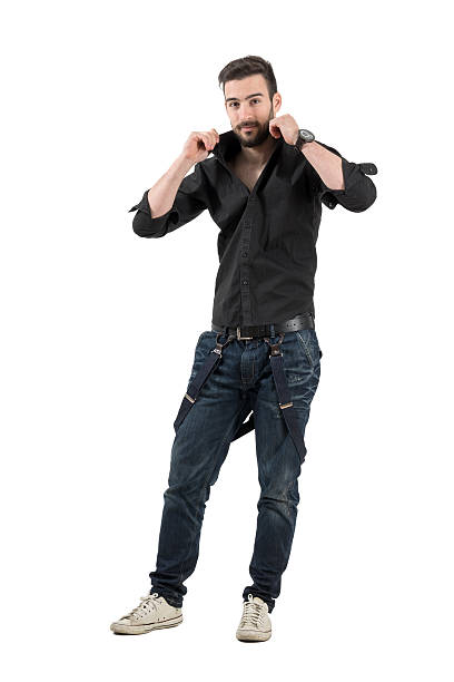 istock Handsome bearded young man adjusting collar on his black shirt 472800428