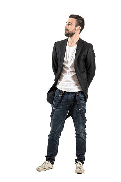 istock Fashionable young guy with hands on his back looking up 472800564