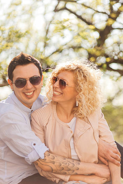 istock happy young couple in the park 472801634