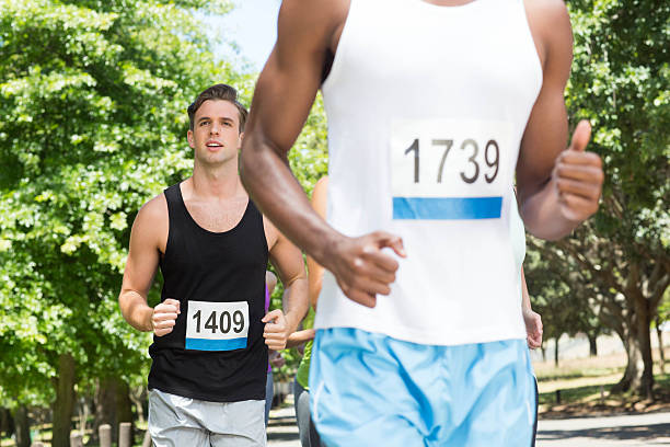 istock Happy people running race in park 472802100