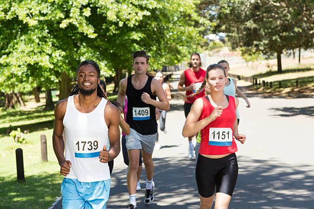 istock Happy people running race in park 472802140