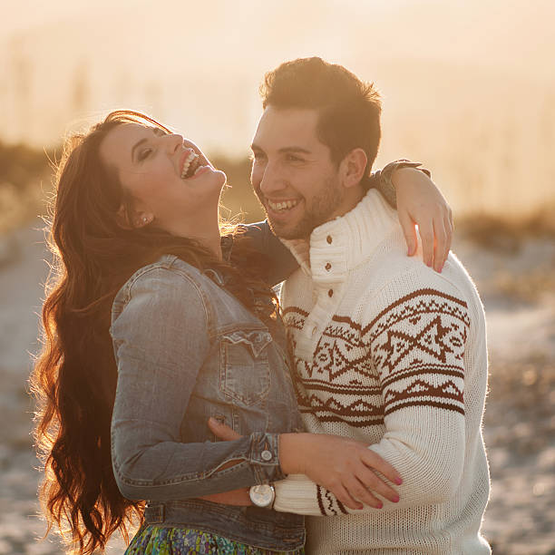 istock Lovely young couple on the sunset beach 472802288