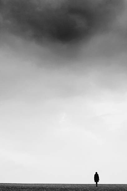 istock Girl walking in field 472802416