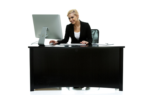 Smiling businesswoman working in officehttp://www.twodozendesign.info/i/1.png