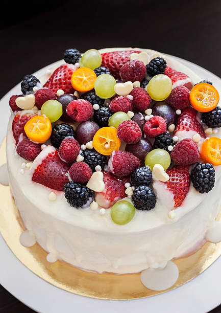 istock White chocolate cake decorated with fresh berries and fruits 472805322
