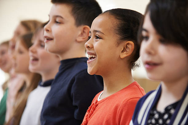 Group Of School Children Singing In Choir Together stock photo