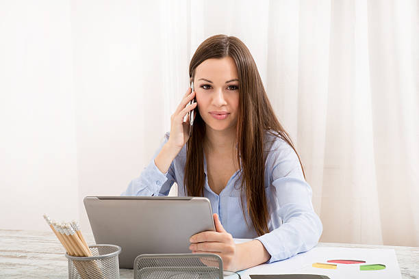 istock Working at the office and talking by phone 472806562