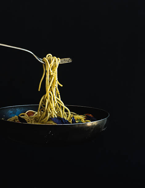 Hot spaghetti with tomatoes in cooking pan