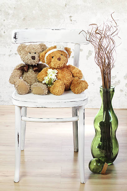 istock Two in love teddy bears sit on a chair. 472806714