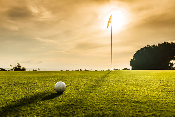 Golf Flag and Ball At Sunset