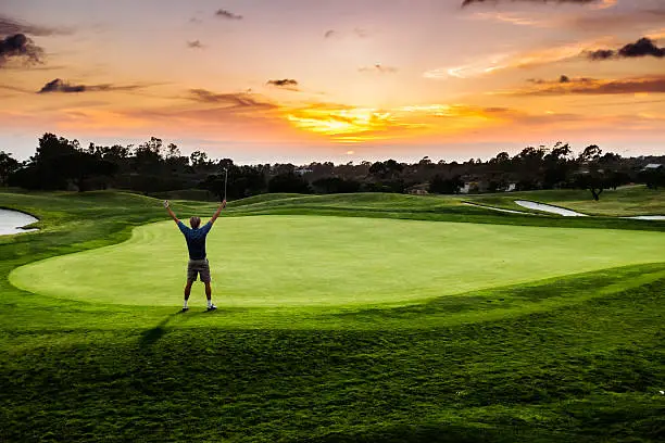 A silhouette of a golfer celebrating a made putt with a sunset.  http://blog.michaelsvoboda.com/GolfBanner.jpg