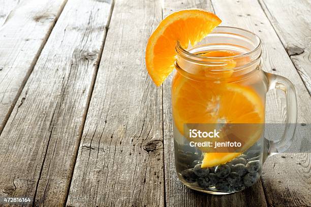 Water With Oranges And Blueberries Against Wood Stock Photo - Download Image Now - 2015, Blue, Blueberry