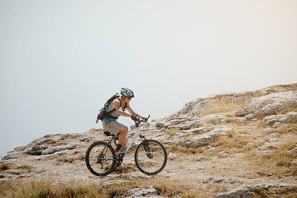 istock Cyclist climbs up the mountain 472822094