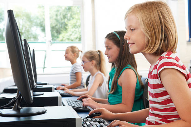 istock Group Of Female Elementary School Children In Computer Class 472822428