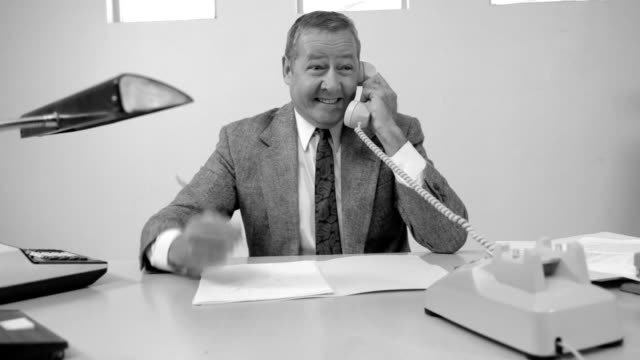 Business man talks on telephone