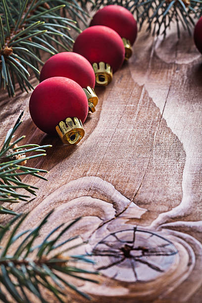 istock row of red christmas baubles branches fir tree on old 472823430