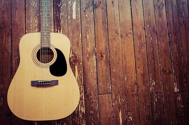 Acoustic Guitar on Wood Background