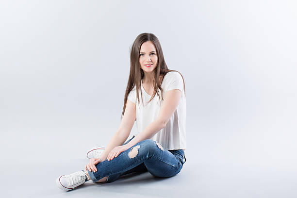 istock Young girl sitting on the floor 472826844