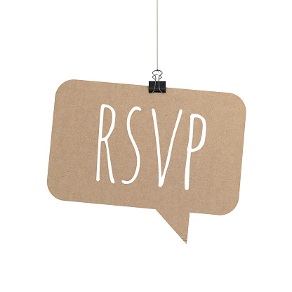 A  3D representation of a speech bubble hanging on a plain white background. The speech bubble is hanging from a binder paper clip that is attached to a piece of string. The bubble has a cardboard texture. The background is pure white. written on the speech bubble in white text is RSVP