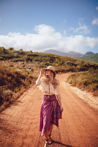 istock Boho girl walking on a dirt road in summer 472830490