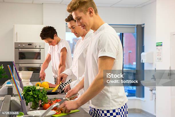 Group Of Student Chefs Learning With Instructor Stock Photo - Download Image Now - Cooking, Young Men, 16-17 Years