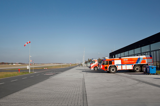 Frankfurt, Germany - October 31, 2011: Two fire engines waiting in front of Feuerwache 4 (fire department 4) at Frankfurt Airport, runway Northwest. Frankfurt Airport is the largest airport in Germany.