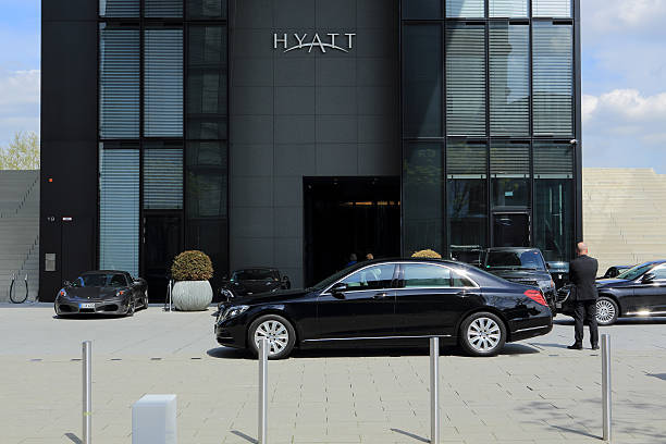 limousines at the Hyatt hotel in Dusseldorf Dusseldorf, Germany - May 1, 2015: Luxury limousines and a chauffeur in front of the Hyatt Regency hotel in Dusseldorf media harbor district. media harbor photos stock pictures, royalty-free photos & images