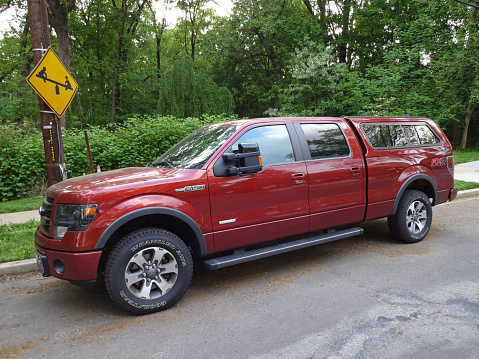Washington DC, USA-May 7, 2015:  This Ford F150 FX4 Off Road truck was spotted in a quiet Northwest Cleveland Park neighborhood in Washington DC.  This is a large vehicle with 4 doors and an optional cover for the back.  The Ford F150 series of trucks is very popular combining value and practicality.
