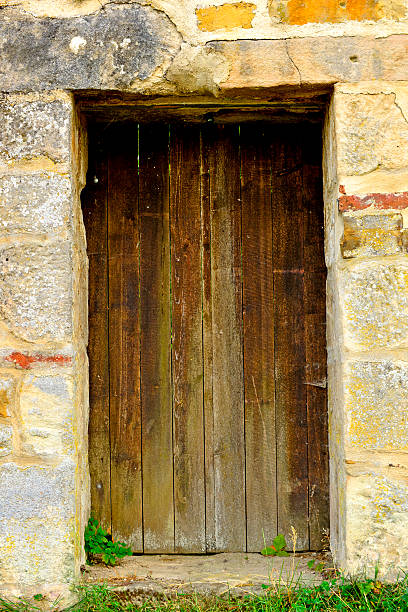 istock old,medieval wall with door 472835380